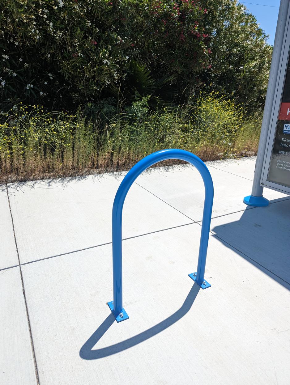 Blue VTA bike rack next to a bus shelter