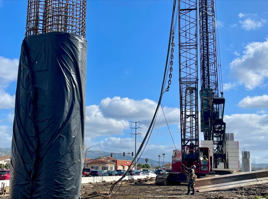 A large crane and two workers